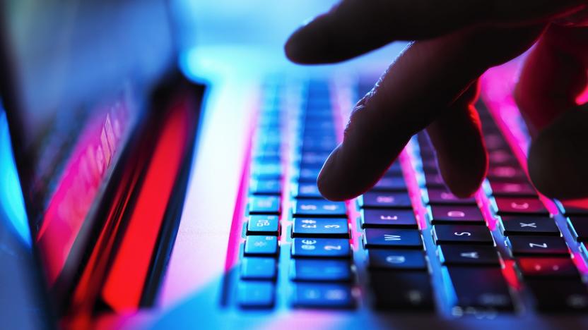 Man typing at his laptop computer at night