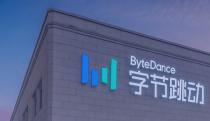 Image (at either dusk or dawn) of part of the building for ByteDance headquarters with the company's name and logo near the roof.