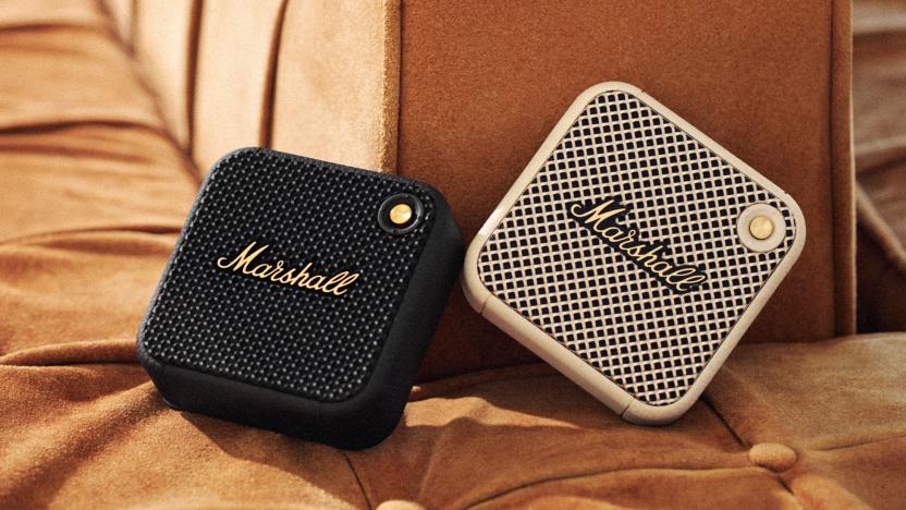 Two of the Marshall Willen micro Bluetooth speakers on a fabric banquet.