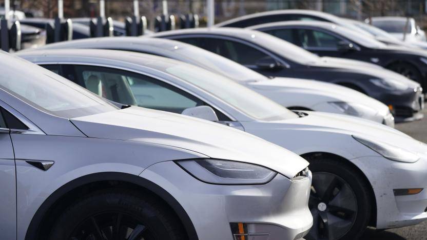 A long row of unsold 2021 Model 3 sedans sits at a Tesla dealership Sunday, Dec. 27, 2020, in Littleton, Colo. (AP Photo/David Zalubowski)