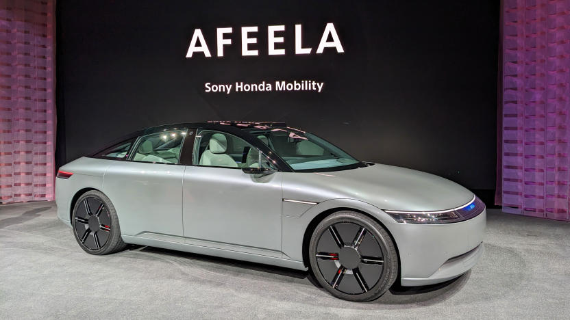The Vision-S 02 electric SUV is now the Afeela, on display at CES 2023 on a low carpeted stage with the name in the background.