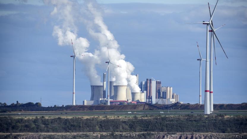 FILE - A flock of sheep graze in front of a coal-fired power plant at the Garzweiler open-cast coal mine near Luetzerath, western Germany, Sunday Oct. 16, 2022. About 1,000 miles away from Ukraine, Luetzerath is an indirect victim of the war as the town will soon make way for the expansion of a nearby coal mine. Environmentalists have been up in arms about the decision which would pump millions more tons of planet-warming carbon dioxide into the air. (AP Photo/Martin Meissner, File)