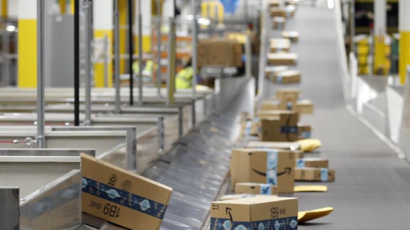 FILE - In this Dec. 17, 2019, file photo, Amazon packages move along a conveyor at an Amazon warehouse facility in Goodyear, Ariz. Amazon will report quarterly earnings on Thursday, APril 30, 2020, providing a first glimpse into its financial performance during the pandemic.  (AP Photo/Ross D. Franklin, File)