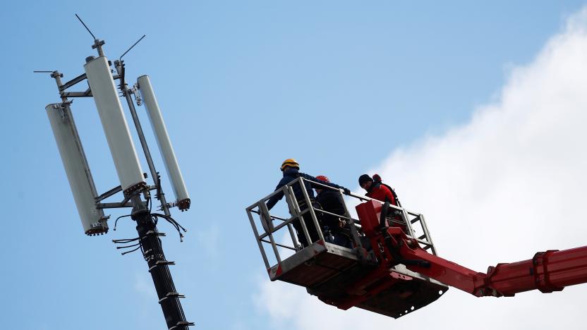 Workers mount antennas at a cell tower in Berlin, Germany, March 19, 2019. REUTERS/Hannibal Hanschke