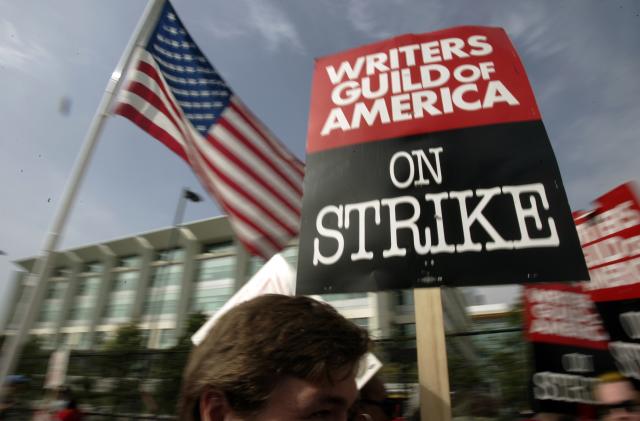 FILE - Writers Guild of America (WGA) writers and others strike against the Alliance of Motion Picture and Television Producers (AMPTP) in a rally at Fox Plaza in Los Angeles' Century City district on Nov. 9, 2007. Television and movie writers on Monday, May 1, 2023, declared that they will launch an industrywide strike for the first time since 2007, as Hollywood girded for a shutdown in a dispute over fair pay in the streaming era. (AP Photo/Reed Saxon, File)