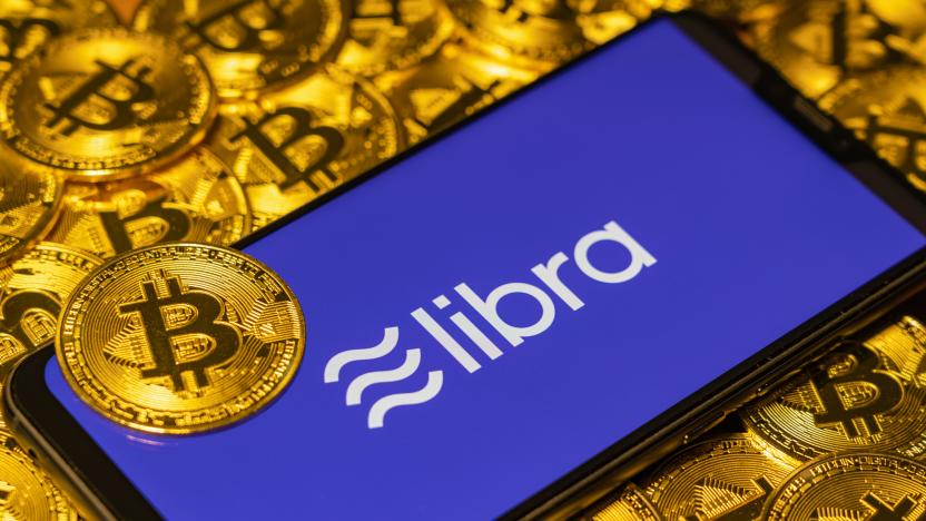 Gold Bitcoin Coins pile with the Facebook's Libra Crypto Coin logo on smartphone screen