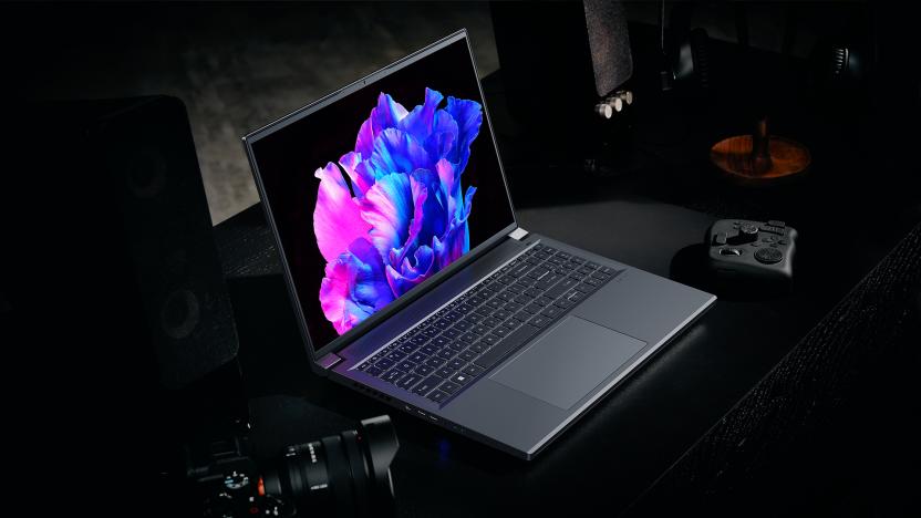 Acer Swift X 16 Promotional Image, with the Swift X sat on a dark table shrouded in darkness, the hint of a drone controller and a DSLR lurking in the gloom.