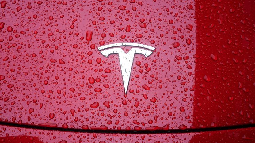 A Tesla logo is pictured on a car in the rain in the Manhattan borough of New York City, New York, U.S., May 5, 2021. REUTERS/Carlo Allegri