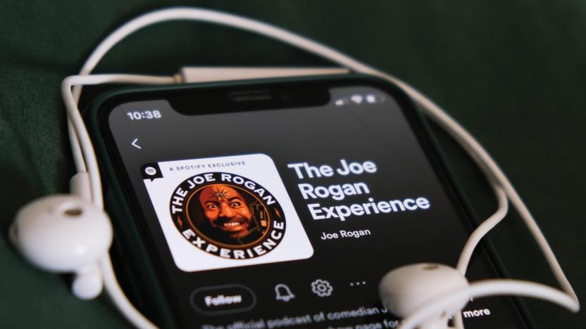 The Joe Rogan Experience podcast on Spotify displayed on a phone screen and headphones are seen in this illustration photo taken in Krakow, Poland on February 3, 2022. (Photo Illustration by Jakub Porzycki/NurPhoto via Getty Images)