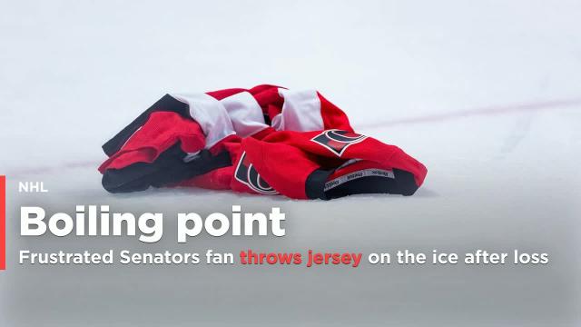 Senators fan throws jersey on the ice after loss