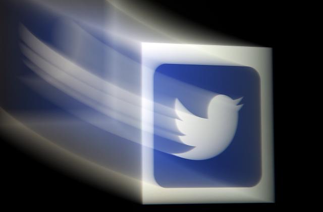 In this photo illustration, a Twitter logo is displayed on a mobile phone on August 10, 2020, in Arlington, Virginia. - Wall Street was mixed early August 10, 2020, with Nasdaq retreating further as investors digested President Donald Trump's efforts to take unilateral action in the absence of a deal with Congress on emergency pandemic spending. About an hour into the first trading session of the week, the tech-rich Nasdaq was down 0.4 percent to 10,963.75, while the Dow Jones Industrial Average gained 0.95 percent to 27,686.07 and the broad-based S&P 500 rose 0.2 percent to 3,357.96. Twitter gained 1.9 percent amid reports the social media giant held talks to combine with Chinese video app TikTok which Trump last week banned from the US amid what he said were security concerns. (Photo by Olivier DOULIERY / AFP) (Photo by OLIVIER DOULIERY/AFP via Getty Images)