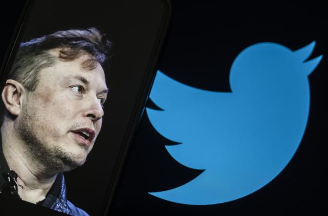 ANKARA, TURKIYE - JULY 24: In this photo illustration, Elon Musk's photo is displayed on a phone screen in front of a computer screen displaying the former logo of 'Twitter' in Ankara, Turkiye on July 24, 2023. (Photo by Emin Sansar/Anadolu Agency via Getty Images)