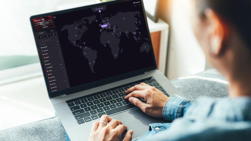 A person uses Proton VPN on a laptop the image of a map is on screen with purple dots indicating server locations. 