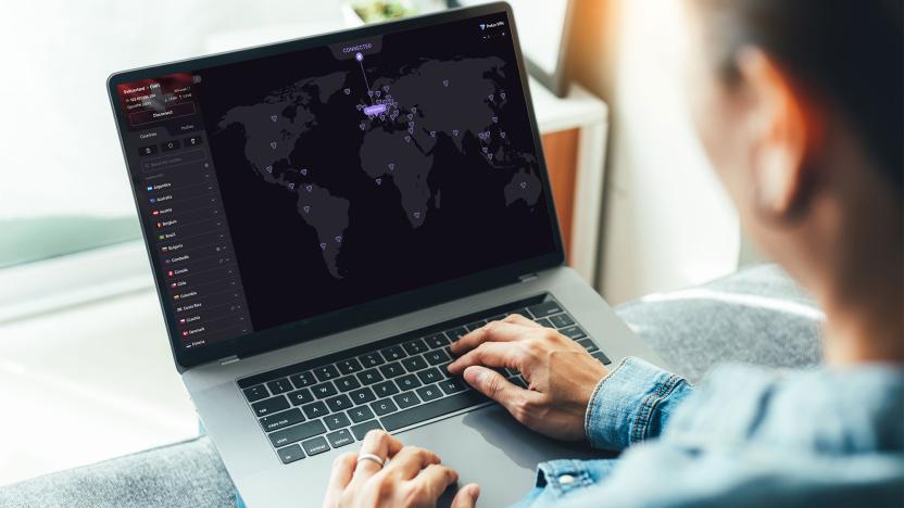 A person uses Proton VPN on a laptop the image of a map is on screen with purple dots indicating server locations. 