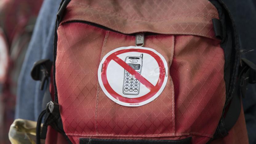 THE HAGUE, NETHERLANDS - SEPTEMBER 9: A protesters carries a backpack with a no-phone sticker during a march against 5G technology on September 9, 2019 in The Hague, Demonstrators are worried about violations of rights concerning, health and radiation, privacy and the environment as tens of thousands of new masts are planned to be installed. Especially long-term effects like cancer, Alzheimer disease and immune illnesses are seen as a threat. (Photo by Michel Porro/Getty Images)