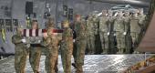 An Air Force carry team moves a transfer case containing the remains of a fallen soldier. (AP)