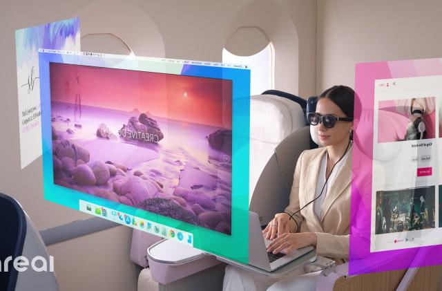 A woman wears Nreal Air augmented reality glasses while on an airplane. Three virtual desktop displays appear to be suspended in midair.