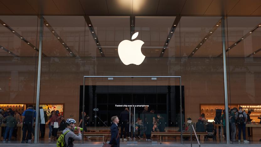 Portland, Oregon, USA - Oct 1, 2019: A man strides past an Apple Store in downtown Portland. The big screen inside is seen advertising Apple's fastest A13 Bionic chips in the new iPhone series.