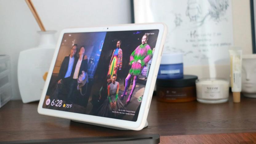 A tablet on top of a wooden table.