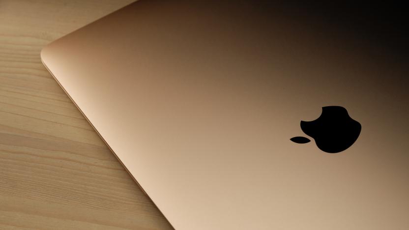 Recanati, Macerata, Italia - June 11, 2020: Brand new rose gold macbook air (2020) on a wooden table with the Apple logo highlighted in black, close up.