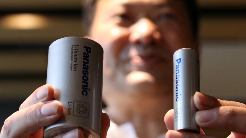 Kazuo Tadanobu, CEO of Panasonic's Energy Company holds a prototype of the 4680 format battery cell (L) next to the current 2170 battery supplied to Tesla Inc during a news conference in Tokyo, Japan October 25, 2021.REUTERS/Tim Kelly