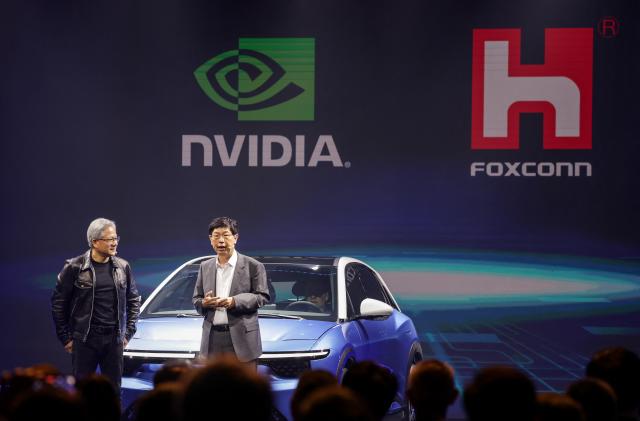 Co-founder and chief executive officer of Nvidia Jensen Huang (L) and Chairman of Foxconn Technology Group Young Liu attend the Hon Hai Tech Day in Taipei on October 18, 2023. (Photo by I-Hwa Cheng / AFP) (Photo by I-HWA CHENG/AFP via Getty Images)