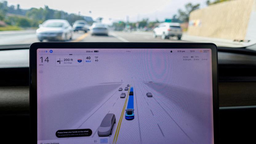 FILE PHOTO: A Tesla Model 3 vehicle warns the driver to keep their hands on the wheel and be prepared to take over at anytime while driving using FSD (Full Self-Driving) in Encinitas, California, U.S., October 18, 2023.     REUTERS/Mike Blake/File Photo