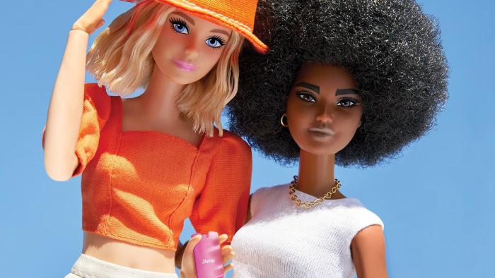 Two Barbies posed next to each other, with one holding a pink Barbie branded filp phone