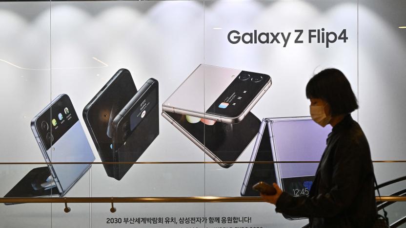 A woman walks past an advertisement for the Samsung Galaxy Z Flip4 smartphone at the company's Seocho building in Seoul on October 7, 2022, after Samsung Electronics expected operating profits in the third quarter to fall 31.7 percent. (Photo by Jung Yeon-je / AFP) (Photo by JUNG YEON-JE/AFP via Getty Images)