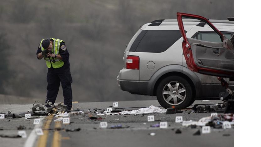 DIAMOND BAR, CALIFORNIA - FEBRUARY 9. 2014: An officer with the California Highway patrol photographs evidence at the wreckage of a car crash on the westbound Pomona Freeway (60) in Diamond Bar on February 9, 2014. A wrong way driver in a Camaro (the very smashed car in front) on the west bound (west of Phillips Ranch Road) crashed head on with a Ford Explorer (middle red SUV) and a Ford Free Style (silver SUV in back). The 21 year old female driver, of Fontana, was charged with felony DUI and manslaughter.  (Photo by Gary Friedman/Los Angeles Times via Getty Images)