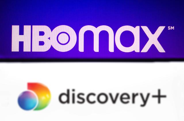 BRAZIL - 2021/05/23: In this photo illustration the Discovery+ (Plus) logo seen displayed on a smartphone with the HBO Max logo in the background. (Photo Illustration by Rafael Henrique/SOPA Images/LightRocket via Getty Images)