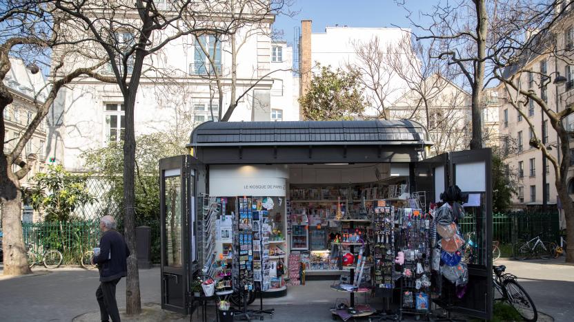 A picture taken on March 19, 2020, shows a man walking by a newspapers kiosk, in front of the Senate in Paris, on the third day of a strict lockdown in France to stop the spread of COVID-19, caused by the novel coronavirus. (Photo by Thomas SAMSON / AFP) (Photo by THOMAS SAMSON/AFP via Getty Images)