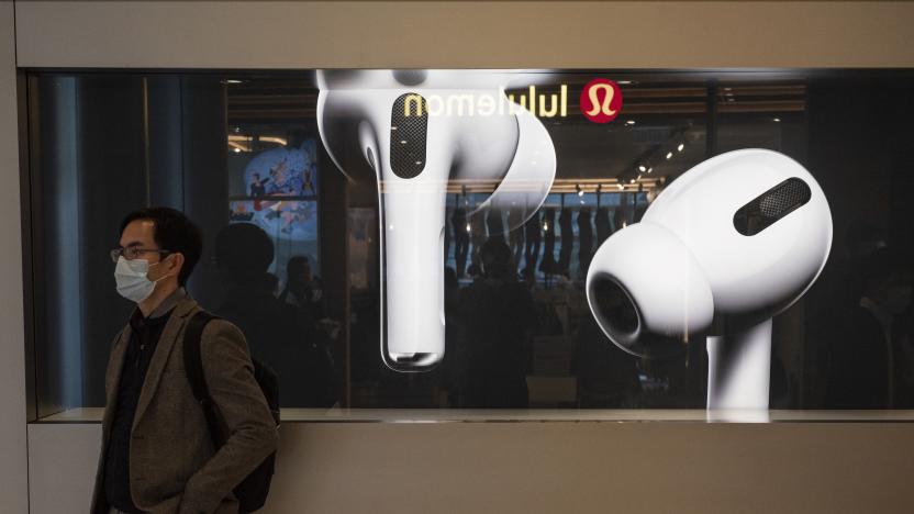 HONG KONG, CHINA - 2020/02/19: A man stands in front of American multinational technology company Apple store displaying the Airpods Pro banner at its entrance in Hong Kong. (Photo by Budrul Chukrut/SOPA Images/LightRocket via Getty Images)