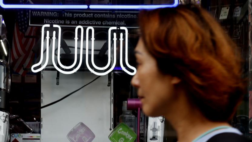 NEW YORK, NEW YORK - JUNE 23: A woman walks in front of a smoke shop on June 23, 2022 in New York. The US Food and Drug Administration has ordered Juul Labs Inc. products to be removed from the US market. (Photo by John Smith/VIEWpress)