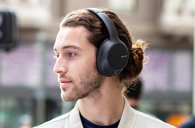 A person wearing Sony's WH-CH710N headphones.