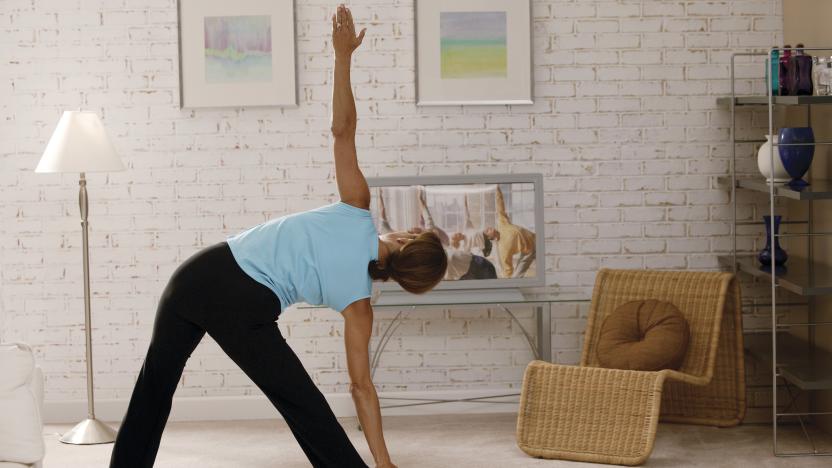 Woman doing yoga to exercise video