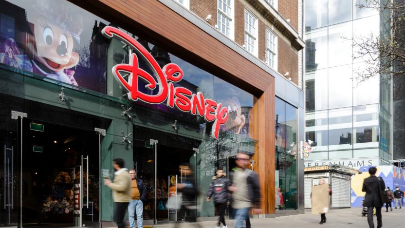 London, UK - 14 March, 2022: wide angle image depicting the exterior of a Disney store in central London, with blurred motion of people walking past on the street outside the shop.