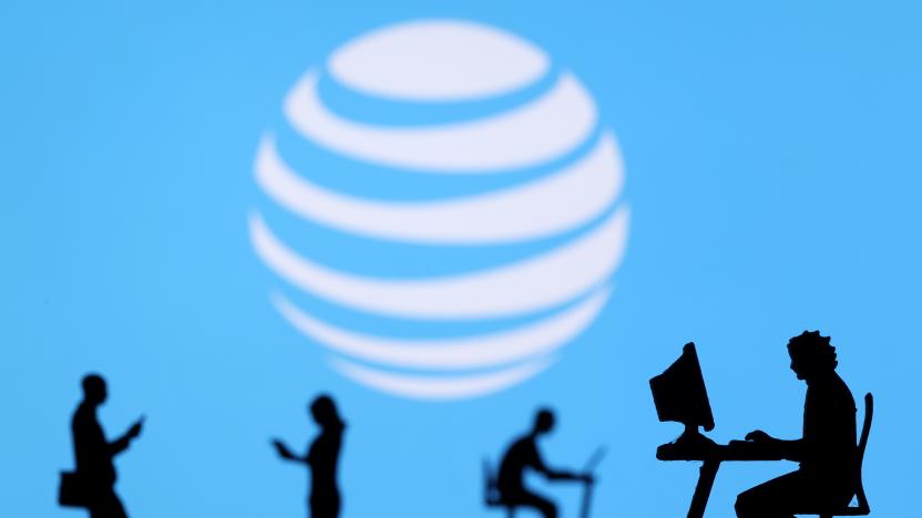 Small toy figures with laptops and smartphones are seen in front of displayed AT&T logo, in this illustration taken December 5, 2021. REUTERS/Dado Ruvic/Illustration