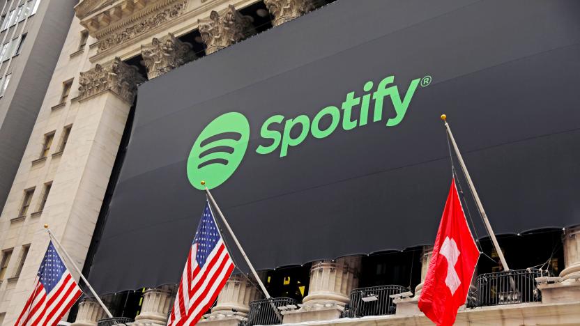 The Spotify logo hangs on the facade of the New York Stock Exchange with U.S. and a Swiss flag as the company lists it's stock with a direct listing in New York, U.S., April 3, 2018.  