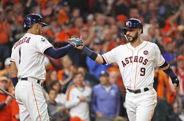 Players from the Astros baseball team shake hands.