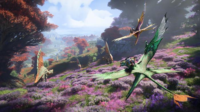 A blue humanoid Na'avi rides on the back of a flying creature over a colorful landscape as dinosaur-like creatures roam in Avatar: Frontiers of Pandora.