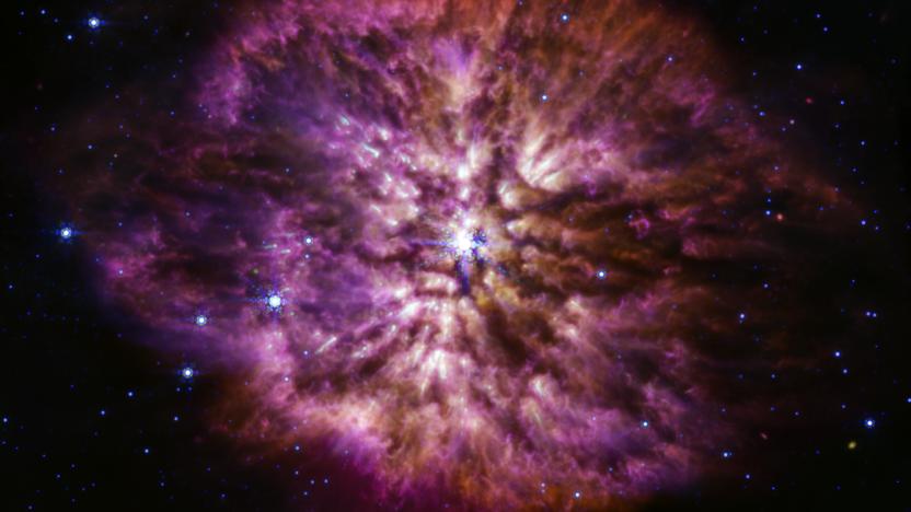 The luminous, hot star Wolf-Rayet 124 is prominent at the center of the James Webb Space Telescope’s composite image combining near-infrared and mid-infrared wavelengths of light from Webb’s Near-Infrared Camera and Mid-Infrared Instrument.