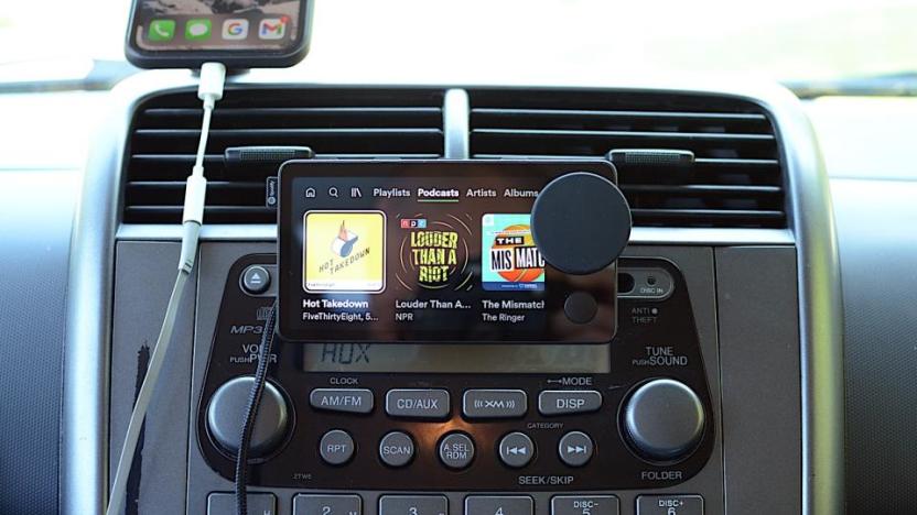 Photo of the Spotify Car Thing, a dash-mounted device with a four-inch screen and dial.