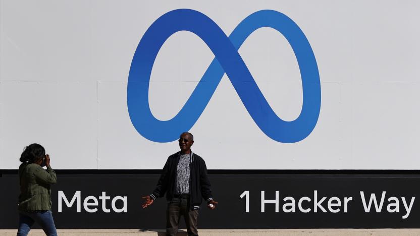 A man poses in front of a sign of Meta, the new name for the company formerly known as Facebook, at its headquarters in Menlo Park, California, U.S. October 28, 2021. REUTERS/Carlos Barria