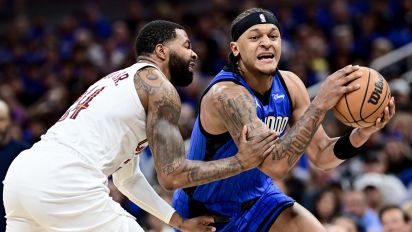 Getty Images - ORLANDO, FLORIDA - MAY 03: Paolo Banchero #5 of the Orlando Magic drives to the basket against Marcus Morris Sr. NOTE TO USER: User expressly acknowledges and agrees that, by downloading and/or using this Photograph, user is consenting to the terms and conditions of the Getty Images License Agreement. #24 of the Cleveland Cavaliers during the first quarter in Game Six of the Eastern Conference First Round Playoffs at Kia Center on May 03, 2024 in Orlando, Florida. NOTE TO USER: User expressly acknowledges and agrees that, by downloading and/or using this Photograph, user is consenting to the terms and conditions of the Getty Images License Agreement.  (Photo by Julio Aguilar/Getty Images)