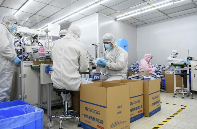 SHENZHEN, March 18, 2020. Staff make masks at the mask producing workshop of Foxconn in Shenzhen, south China's Guangdong Province, March 17, 2020.
  Shenzhen has seen more than 97 percent of the industrial enterprises above designated size and the key projects resume operation. (Photo by Liang Xu/Xinhua via Getty) (Xinhua/Liang Xu via Getty Images)