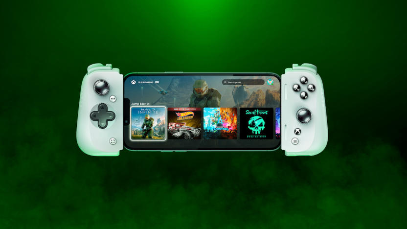 A Razer Kishi mobile controller with a phone in it floats in a green mist with a black background.