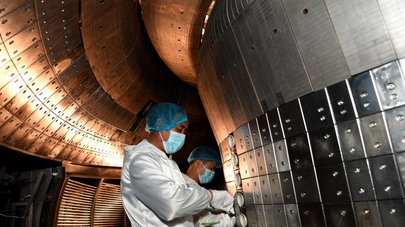 Staff members perform an upgrade to the experimental advanced superconducting tokamak EAST at the Hefei Institutes of Physical Science under the Chinese Academy of Sciences CAS on April 28, 2021. Chinese scientists have set a new world record of achieving a plasma temperature of 120 million degrees Celsius for a period of 101 seconds in the latest experiment on Friday, a key step toward the test running of a fusion reactor.     The experiment at the experimental advanced superconducting tokamak EAST, or the "Chinese artificial sun," also realized a plasma temperature of 160 million degrees Celsius, lasting for 20 seconds. (Photo by Liu Junxi/Xinhua via Getty Images)