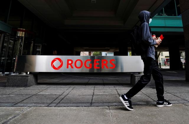 A person walks near the Rogers Building, quarters of Rogers Communications in Toronto, Ontario, Canada October 22, 2021.   REUTERS/Carlos Osorio