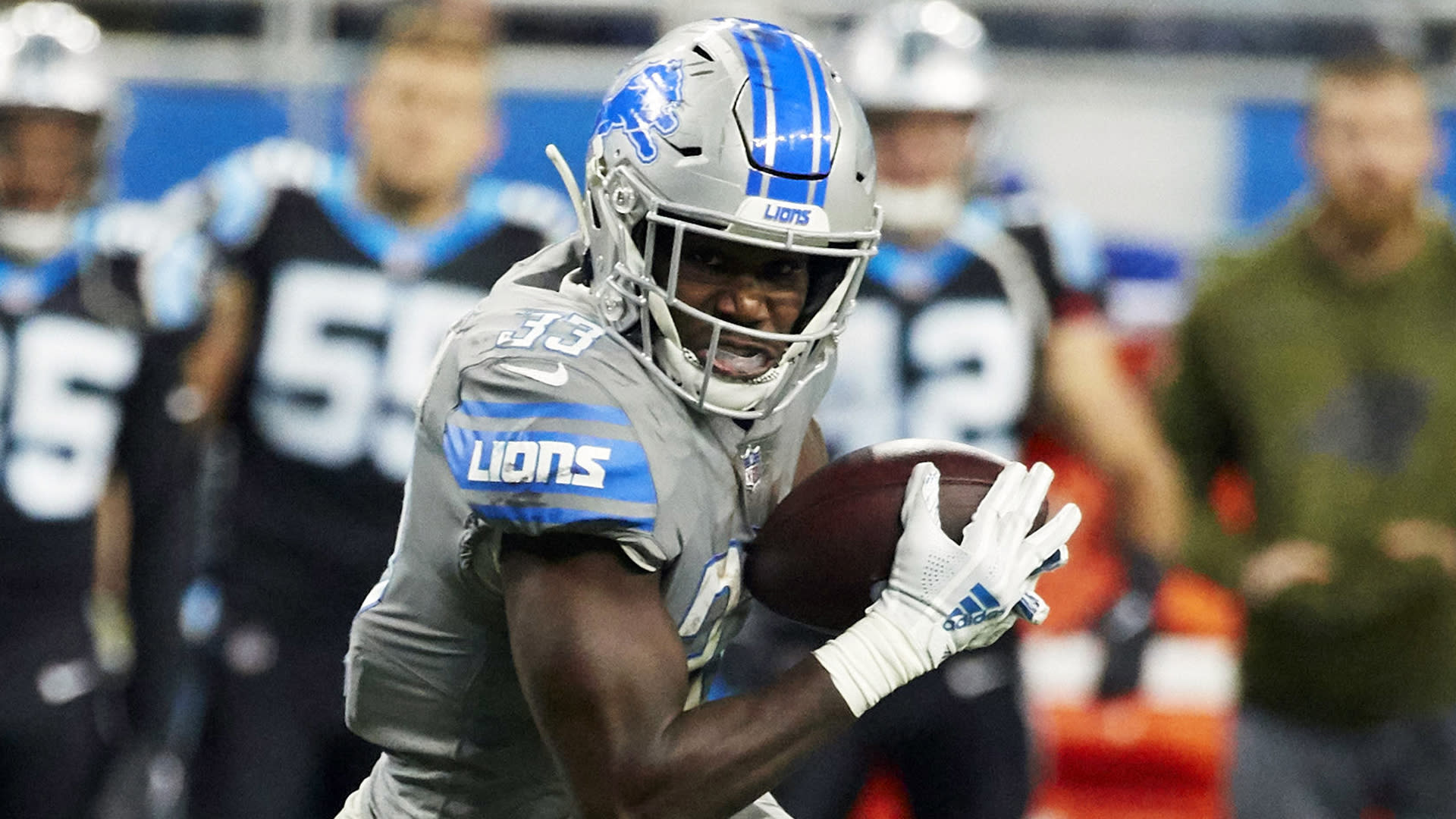 DETROIT, MI - NOVEMBER 26: Detroit Lions running back Kerryon Johnson (33)  runs through a hole in